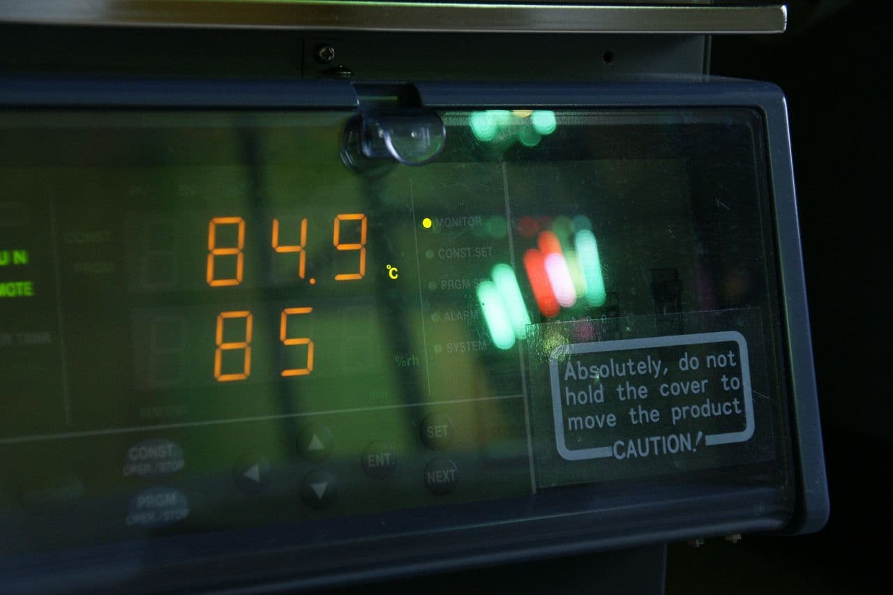 Climate chamber display reading 84.9 degrees Celsius and 85 percent relative humidity during a running LED reliability test.